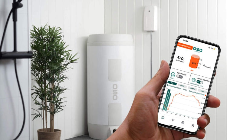 A hand holding a smartphone displaying data about the OSO Saga S Charge unvented cylinder.