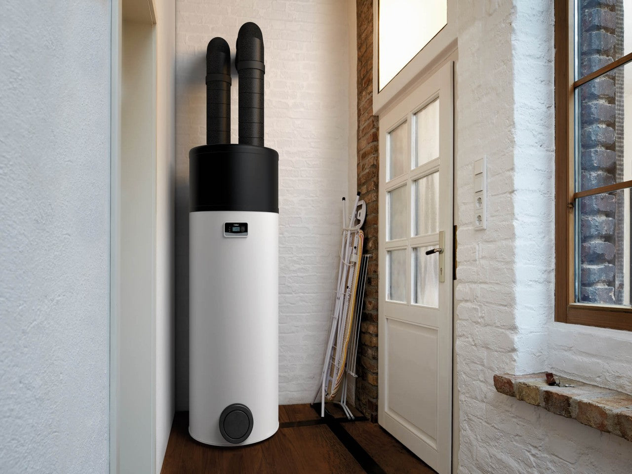 Vaillant aroSTOR heat pump water heaters installed in a modern UK home interior.