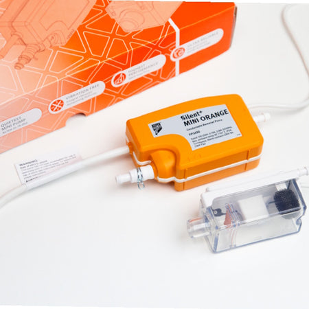 Aspen Pumps Silent Mini Orange aquarium pump with its clear plastic filter cartridge and white tubing, displayed next to its orange retail packaging box on a white surface.