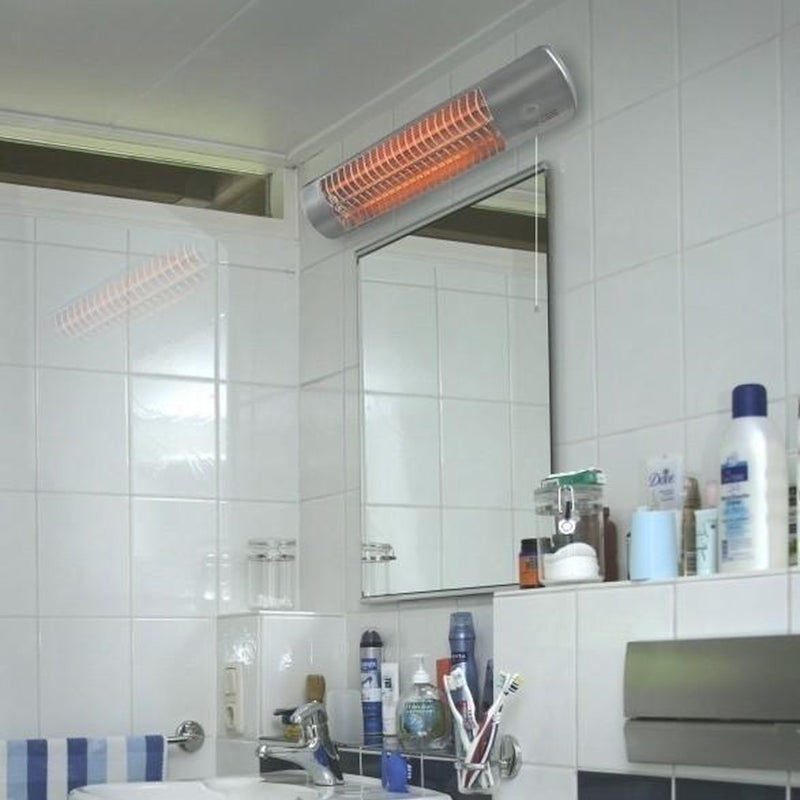 Infrared heater mounted on a bathroom wall with various toiletries on a shelf below.