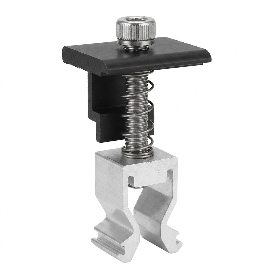 A metal and plastic spring clamp accessory with a black plastic top plate, silver metal spring, and silver aluminum clip base, shown on a plain white background.