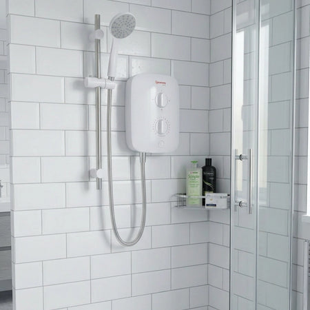 White shower head and control panel mounted on a tiled bathroom wall.