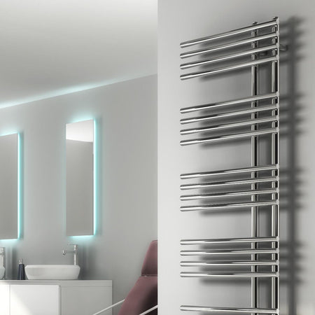 Tall metallic towel radiator mounted on a wall in a bathroom setting.