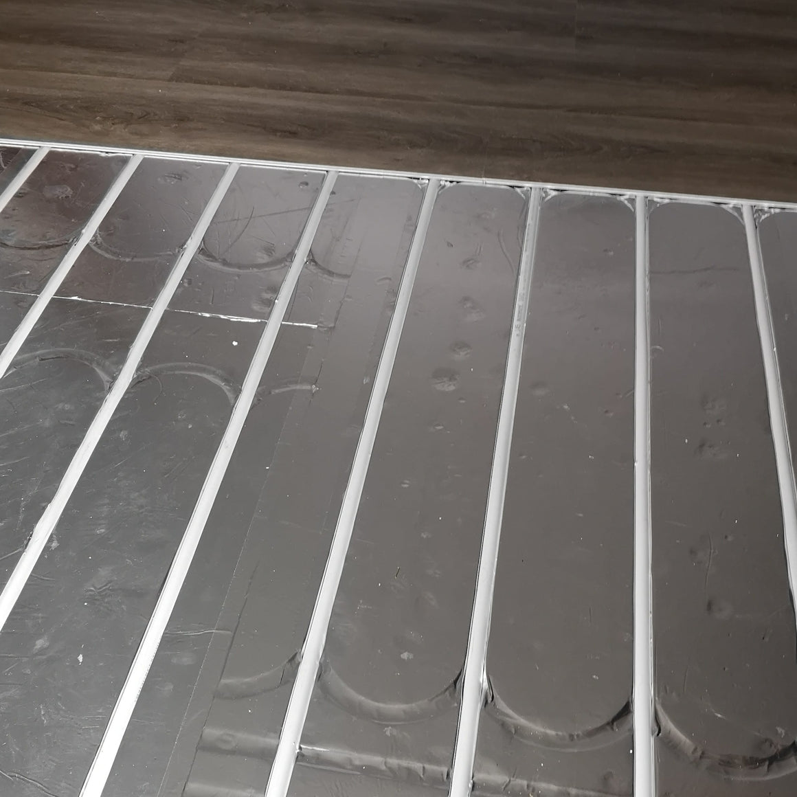ThermRite PRO 16mm dual purpose foiled EPS 400 insulation panel installed with pipe centres for underfloor heating.