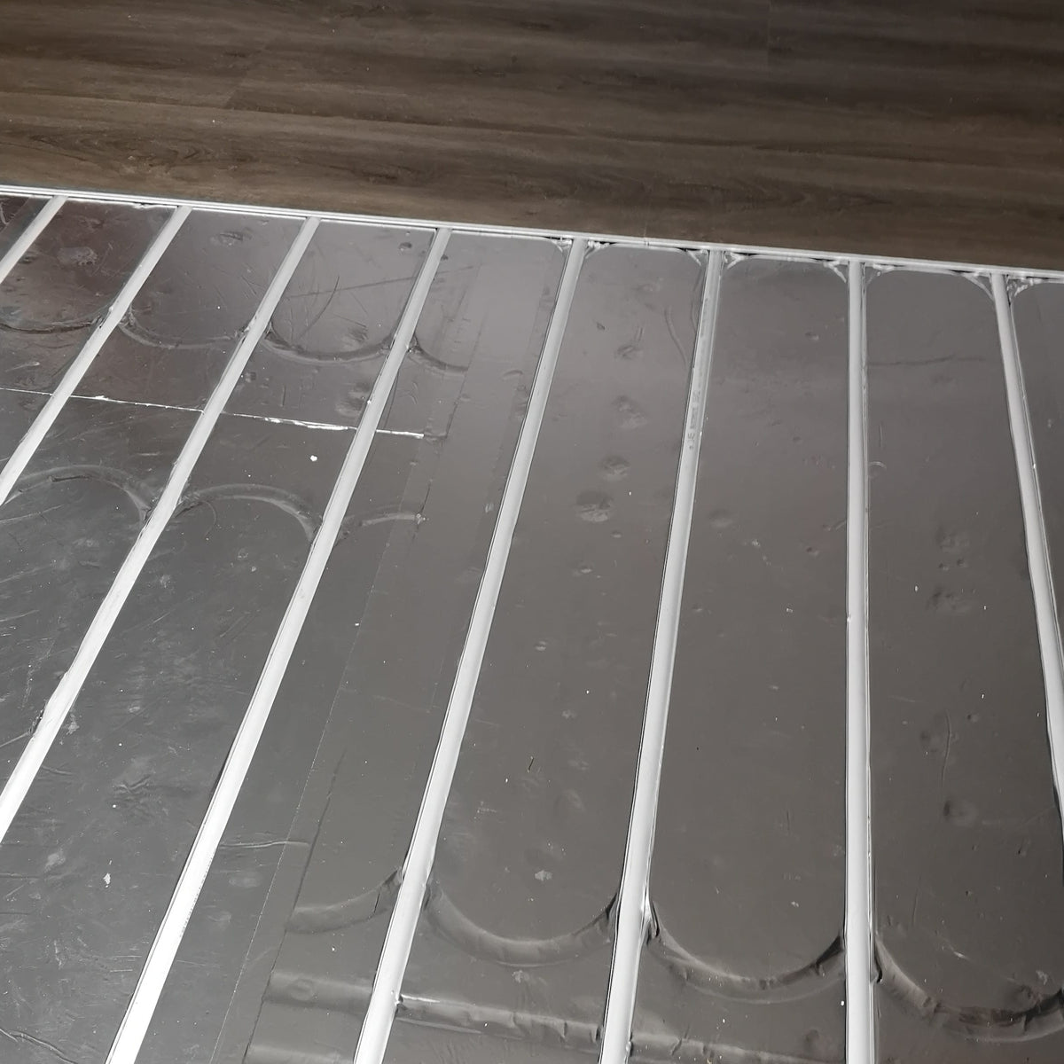 ThermRite PRO 16mm dual purpose foiled EPS 400 insulation panel installed with pipe centres for underfloor heating.