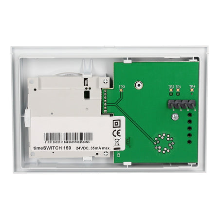 An industrial time switch module, showing the back side with a white plastic housing, a white power supply unit, and a green printed circuit board with terminal labels TP1, TP2, TP3, and TR1.