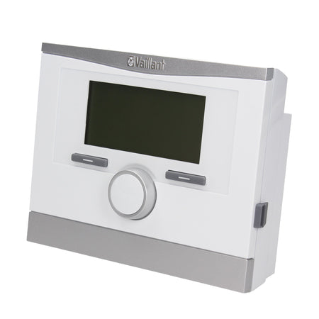 A Vaillant gas boiler or central heating control panel with a white faceplate, silver trim, a central rotary dial, and a dark display screen, shown on a plain white background.