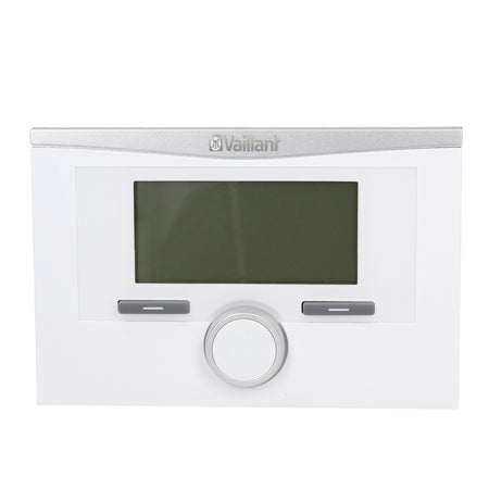 A Vaillant wall-mounted boiler control panel in white and silver, featuring a central dark display screen, two gray buttons, and a central rotary dial.