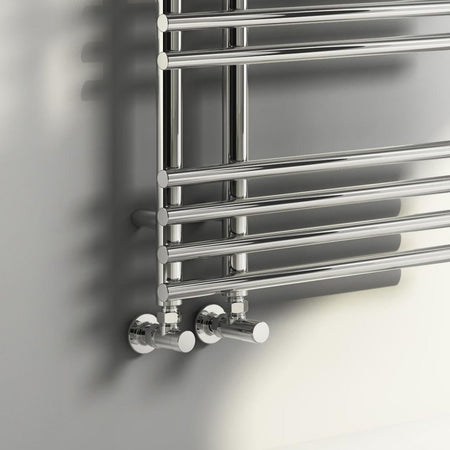 Chrome towel radiator on a gray wall